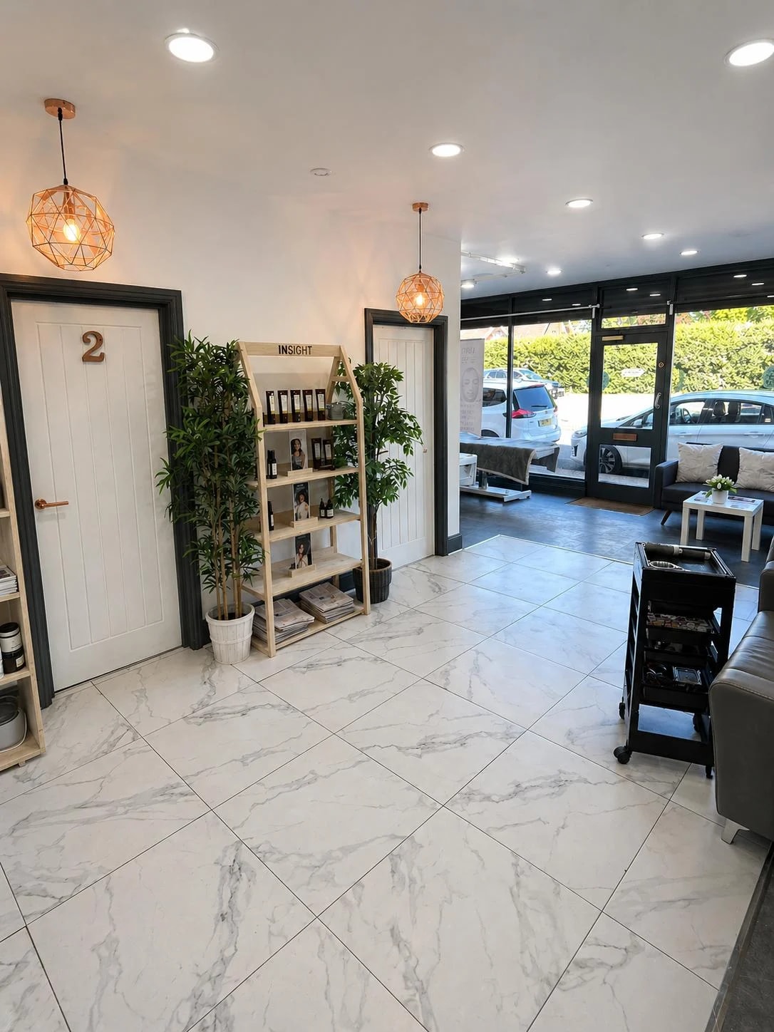 View through The Essentials Lounge towards the entrance, with marble-effect flooring and seating
